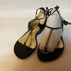 Marc Fisher Black and Gold Sandals with wrap around the ankle. NWOT